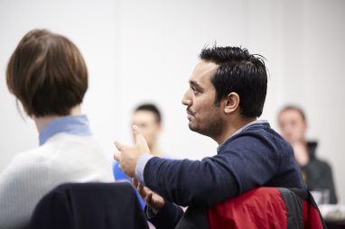 Man talking in classroom group.