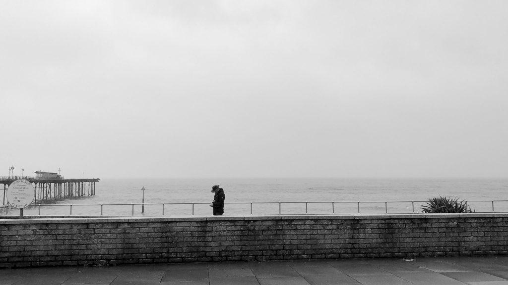 Lone figure on a wet seafront @MandyPearse
